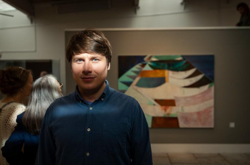 Jens Dam Ziska with his artwork at the National Gallery in the Faroe Islands.