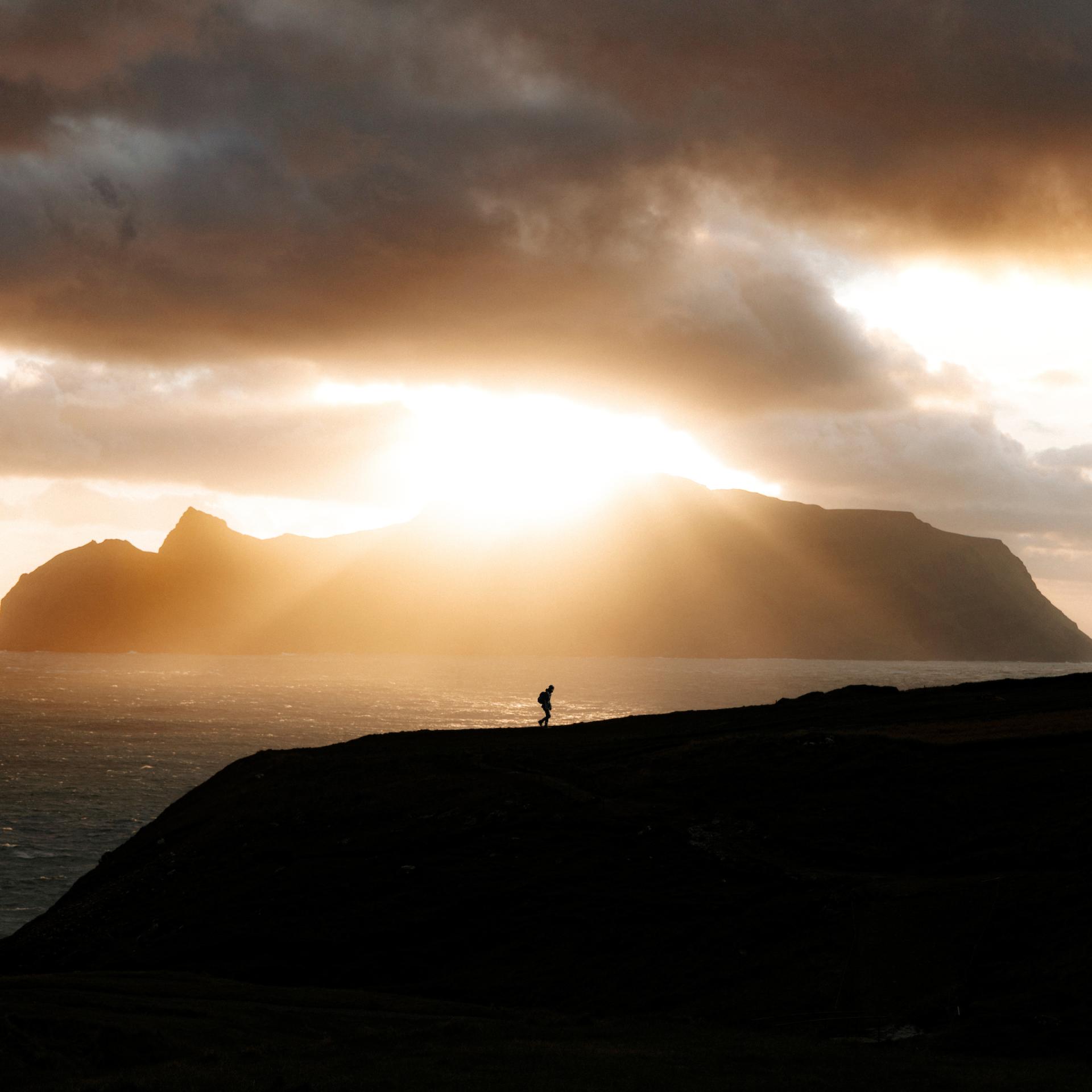 Hiking in the Faroe islands, sun and mountains. By Derek Malou